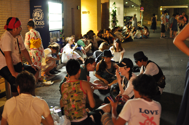 Young people are sitting outside